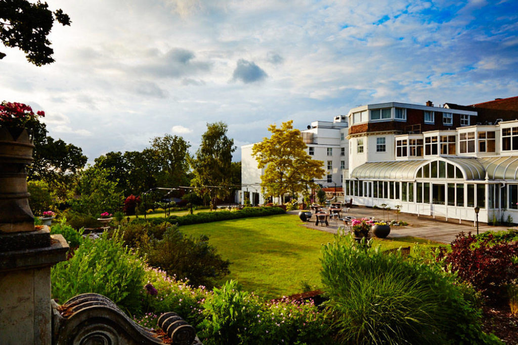 Bromley Court Hotel - A white building with a green lawn, offering event and hotel services.