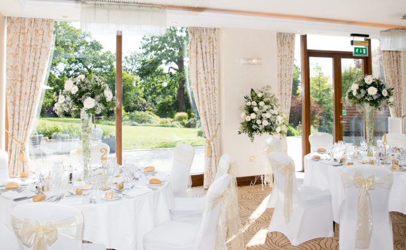 Bromley Court Hotel - A weddings reception at a Bromley hotel with white tablecloths and flowers.
