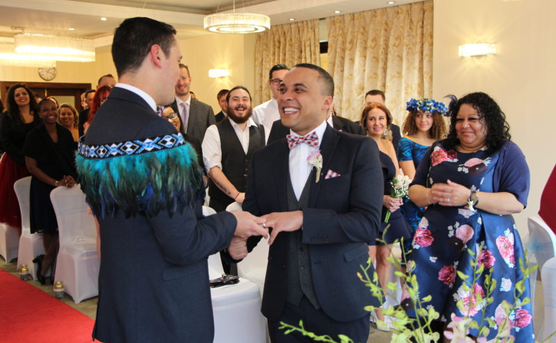 Bromley Court Hotel - Two men shaking hands at a wedding ceremony in a hotel.